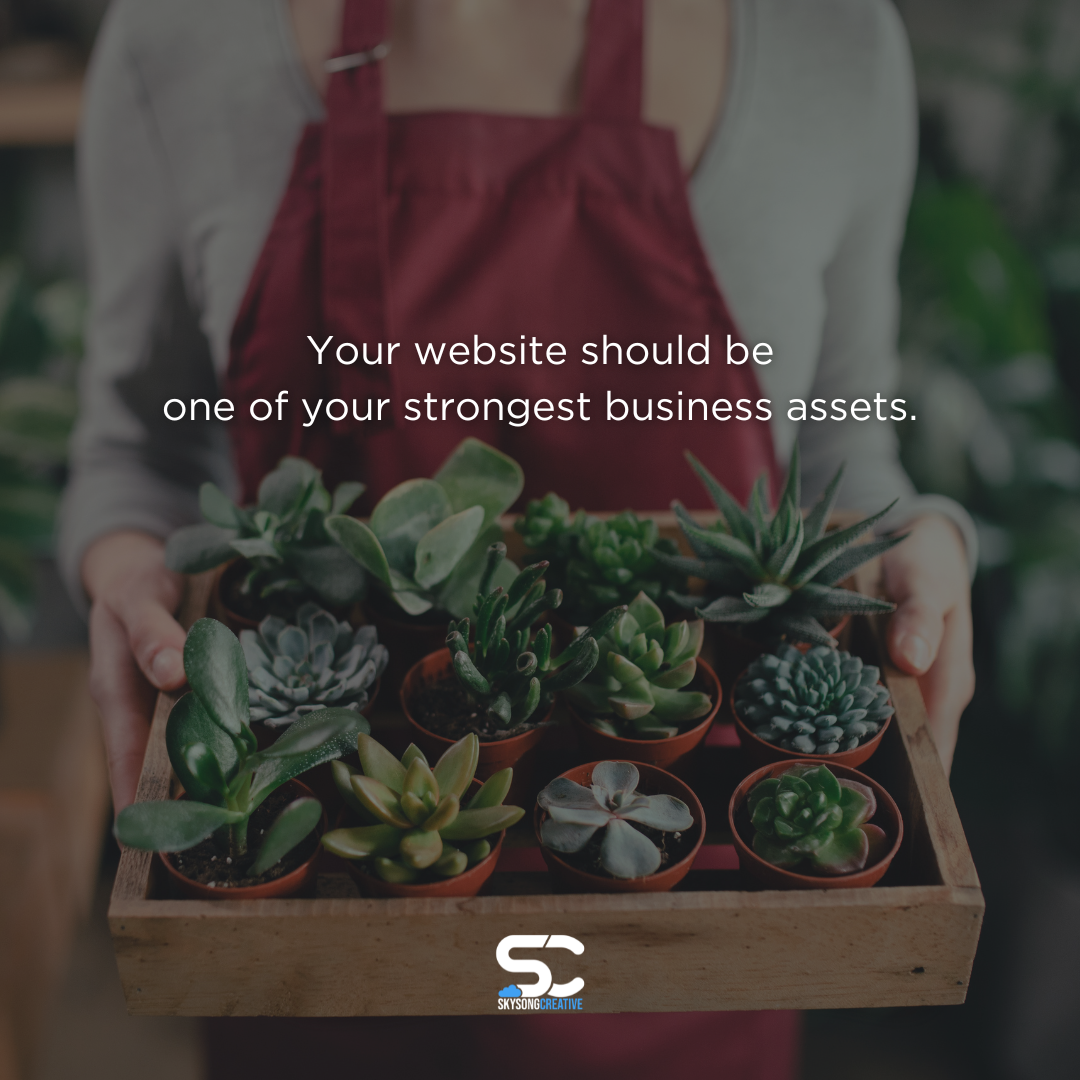 A small business owner holds a tray of succulents inside her shop. Text overlay reads: Your website should be one of your strongest business assets. Skysong Creative